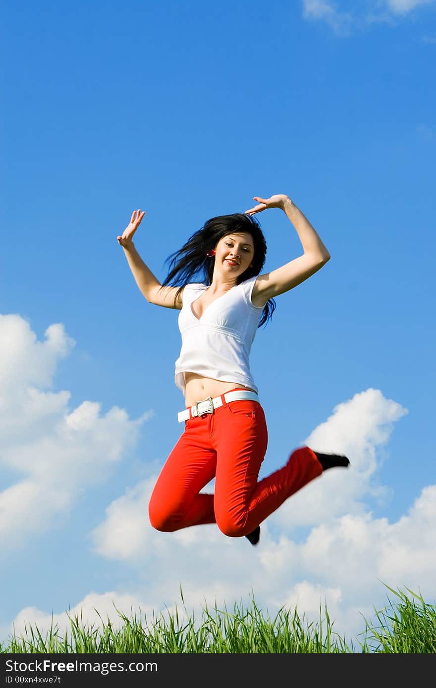 Happy young woman is jumping