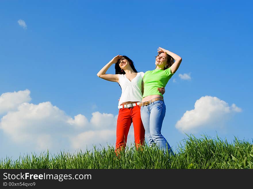 Two young women on a green meadow. Two young women on a green meadow