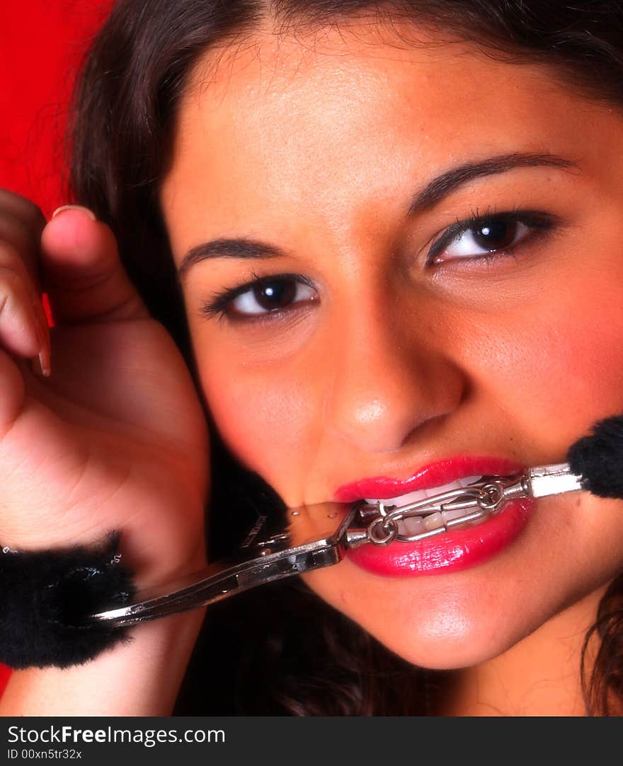 Attractive young woman wearing fuzzy handcuffs. Attractive young woman wearing fuzzy handcuffs