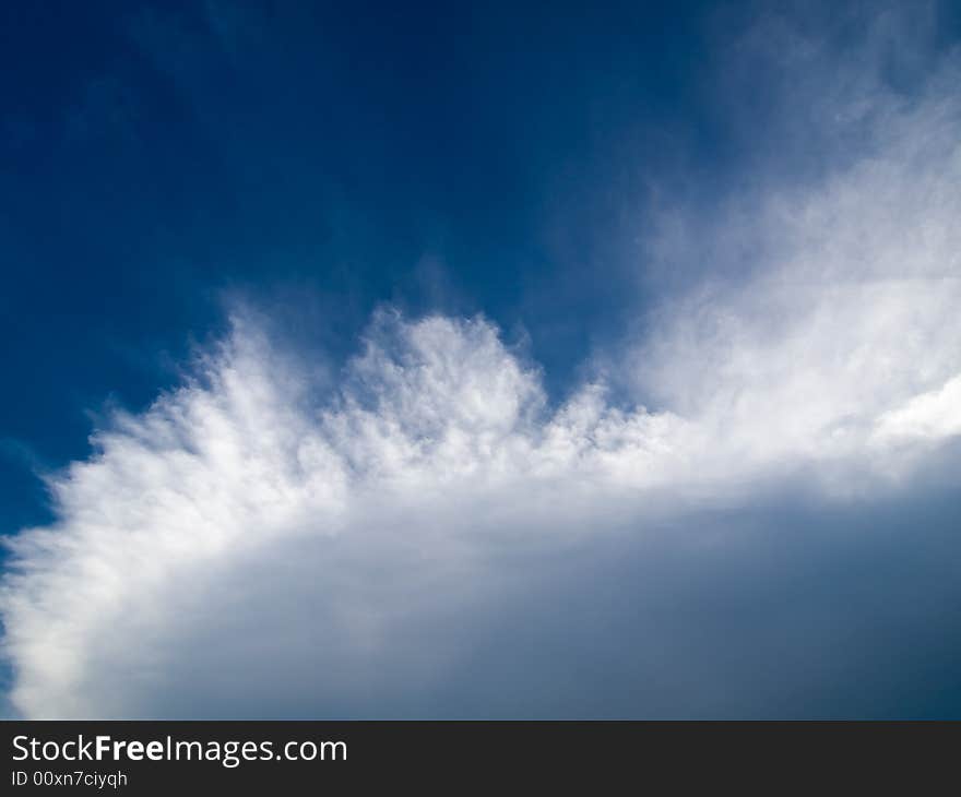 Fissures erupting at the edge of a large cumulus cloud. Fissures erupting at the edge of a large cumulus cloud