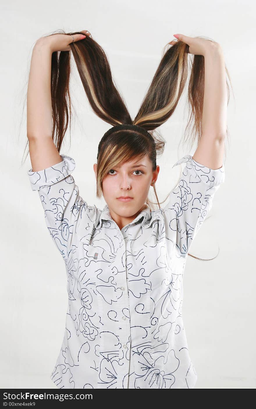 The girl holds the beautiful hair in hands