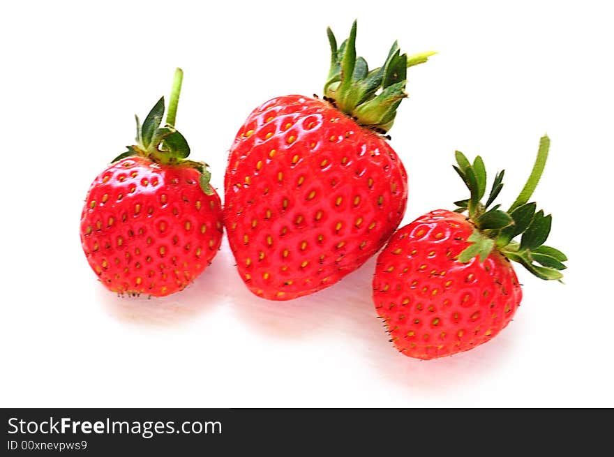 Set of fresh strawberries on white painted board