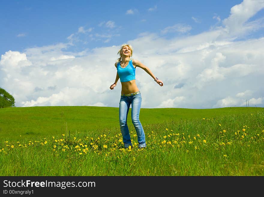 The girl jumping on a lawn