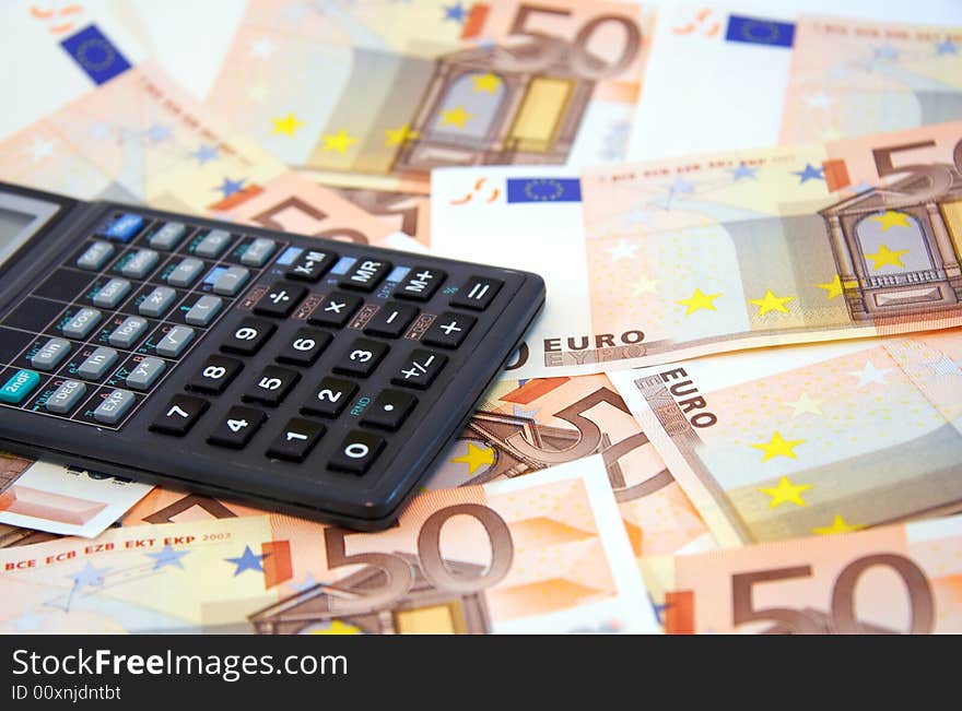 The calculator atop of euro banknotes for backrounds and other