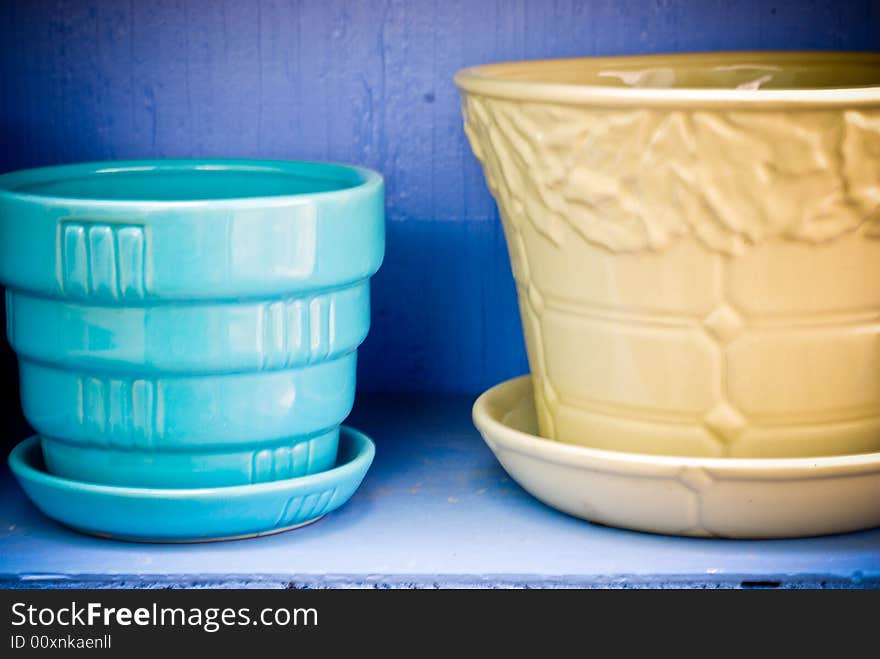 Blue & yellow flowerpots against a periwinkle background. Blue & yellow flowerpots against a periwinkle background.