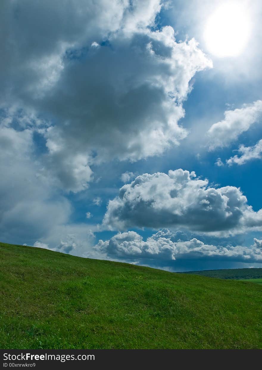 Summer landscape with green grass and blue sky. Summer landscape with green grass and blue sky