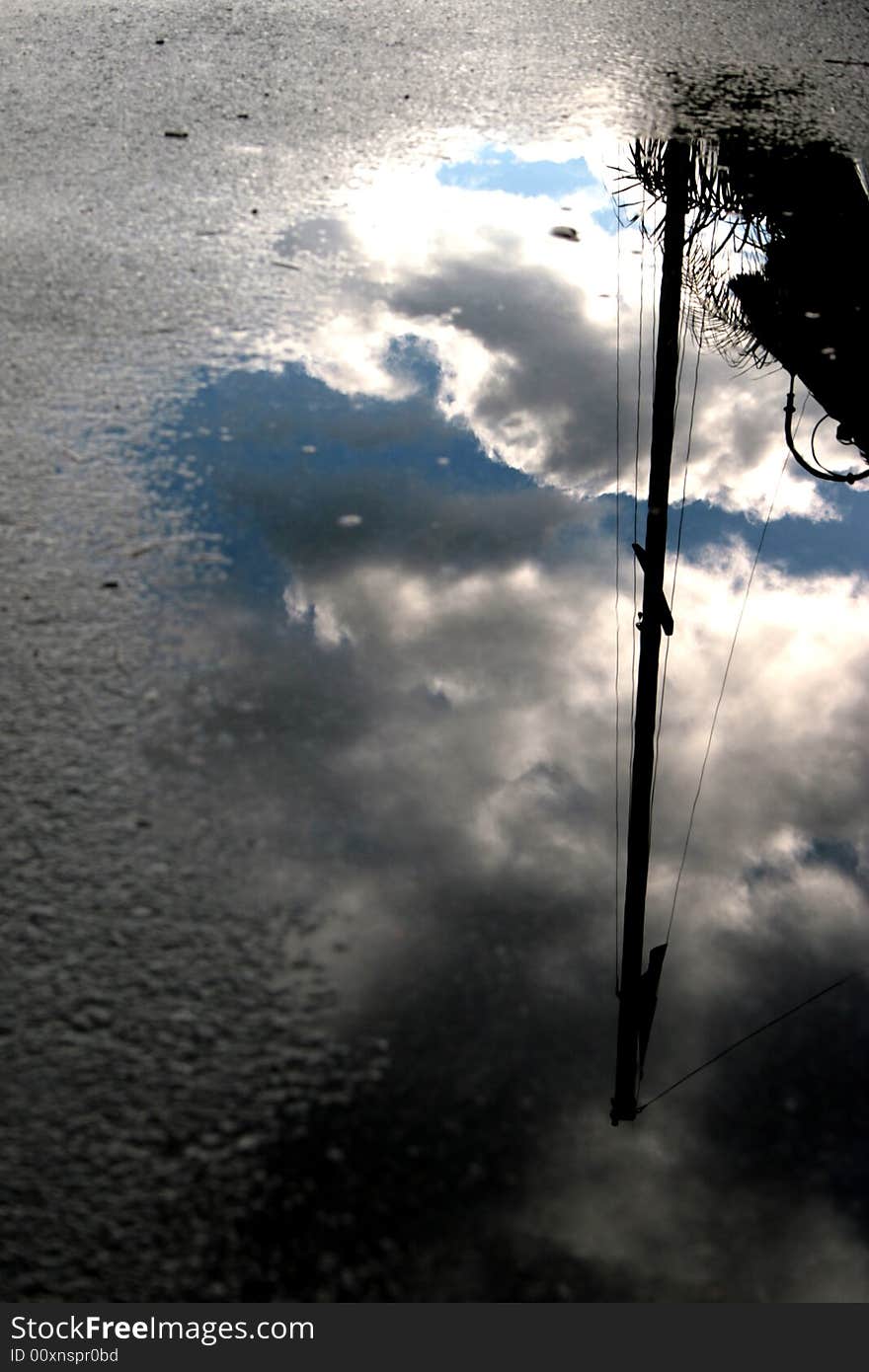 The sky reflected in water mirror. clouds after the storm. The sky reflected in water mirror. clouds after the storm