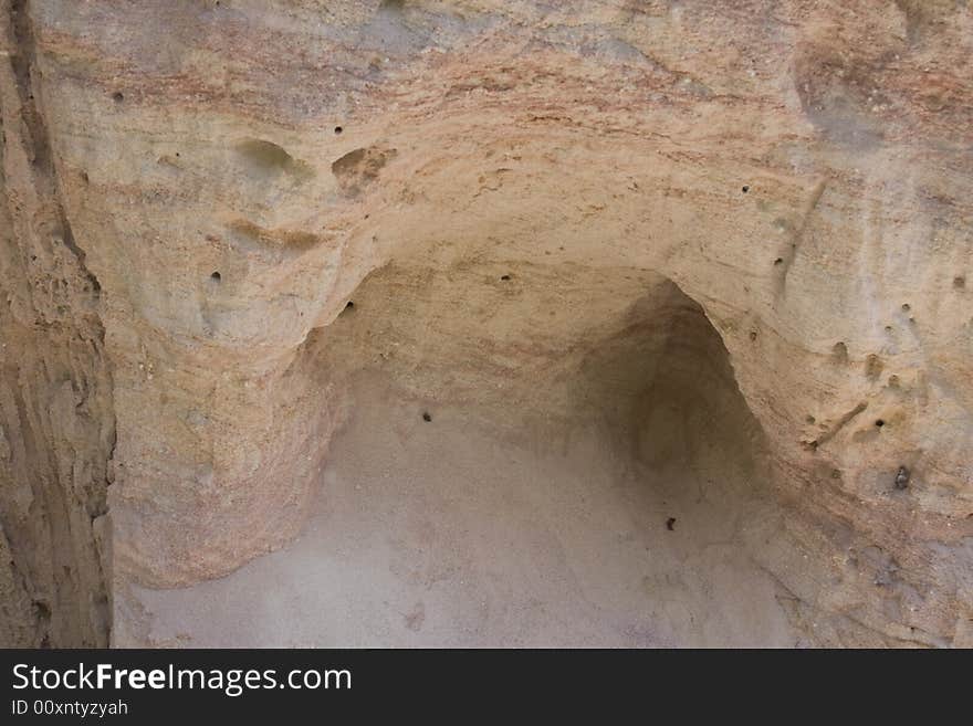 Face characters sculpted into sand wall. Face characters sculpted into sand wall