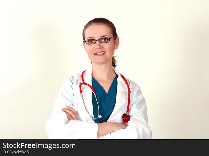 Cute brunette in white medical gown and a stethoscope in an hospital. Cute brunette in white medical gown and a stethoscope in an hospital