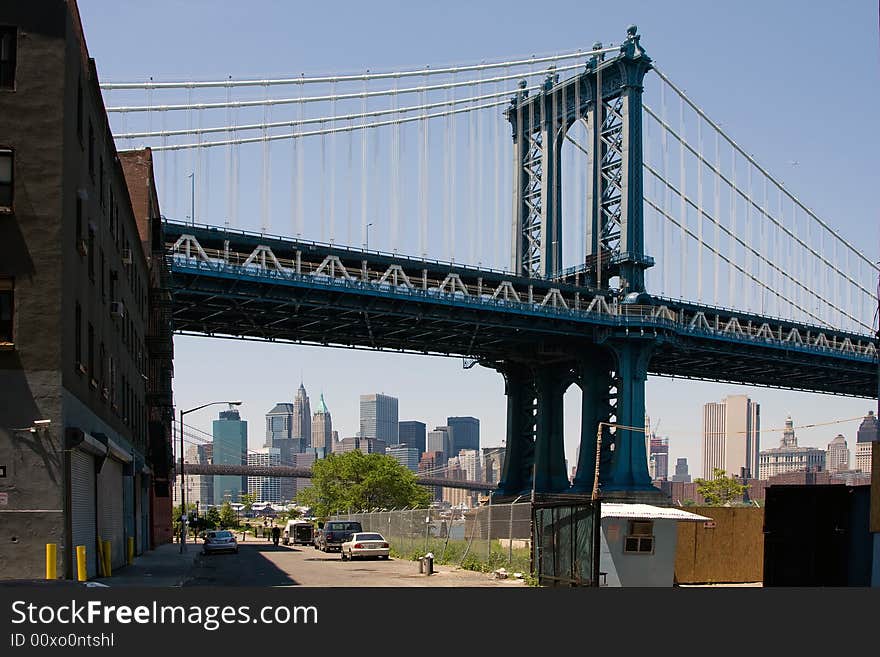 Manhattan Bridge as seen from DUMBO in Brooklyn. Looking at the skyline of Manhattan's financial district with the Brooklyn bridge in front as well.