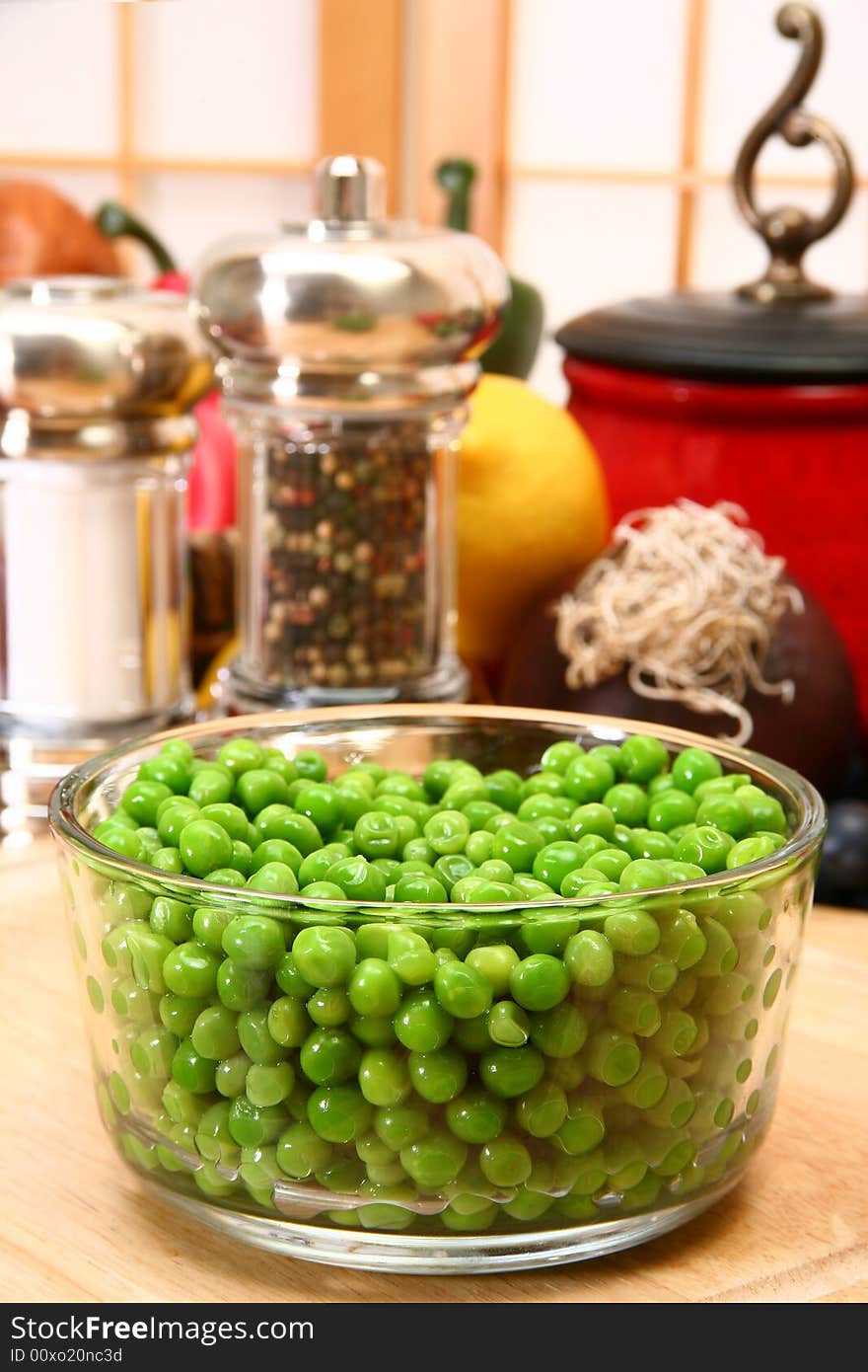 Bowl of fresh green peas in kitchen or restaurant.