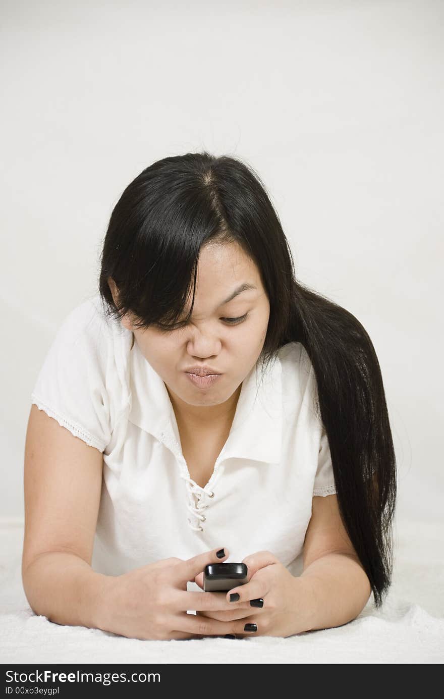 Asian woman texting on celphone