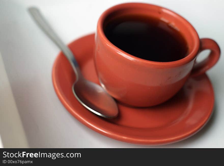 A small cup of coffee, espresso.