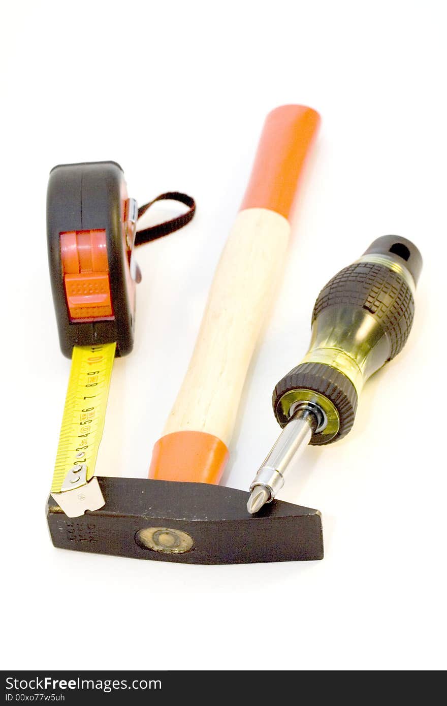 Tape-measure, hammer, screwdriver on the white background