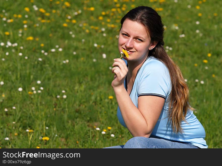 Young attractive female model enjoying flowers