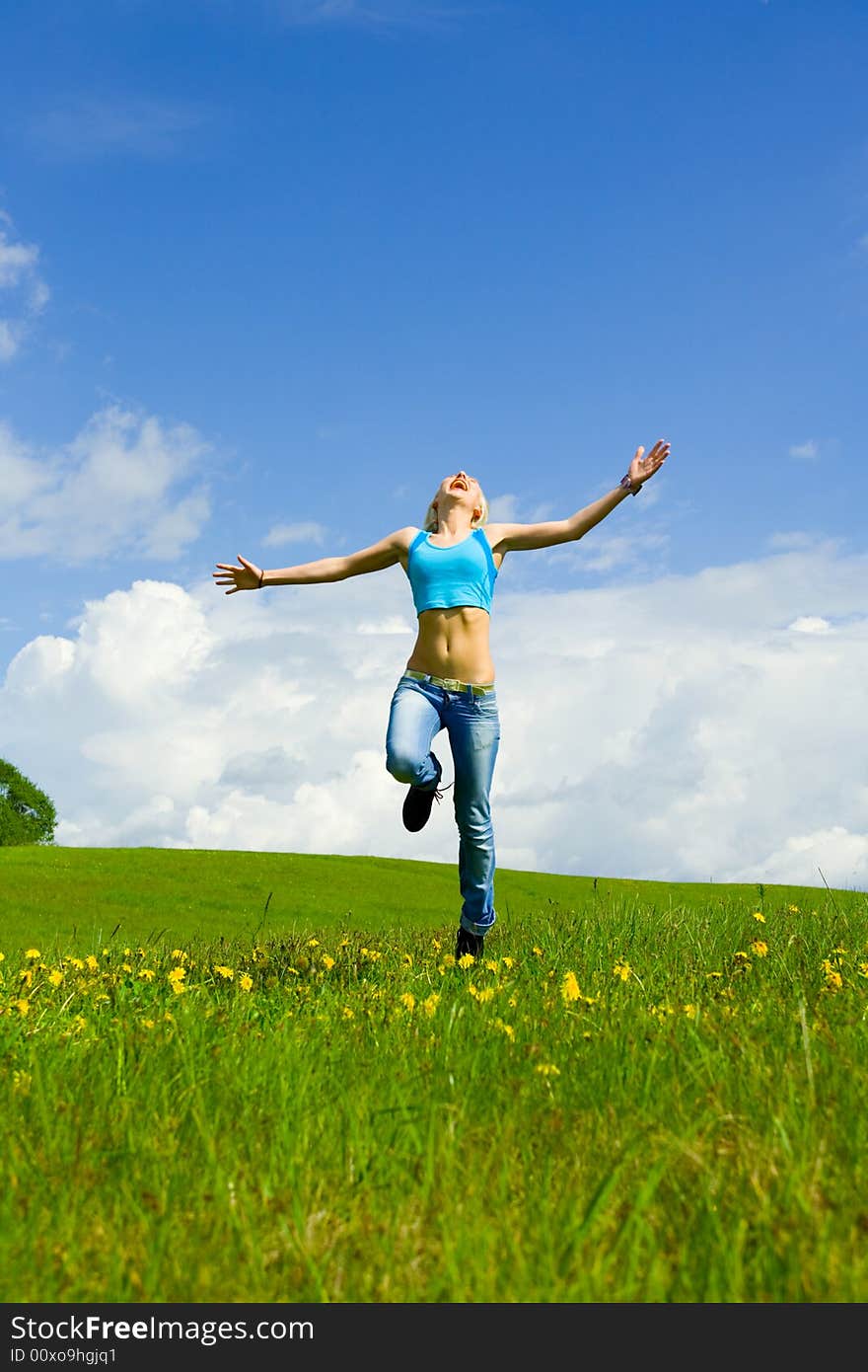 The girl jumping on a lawn