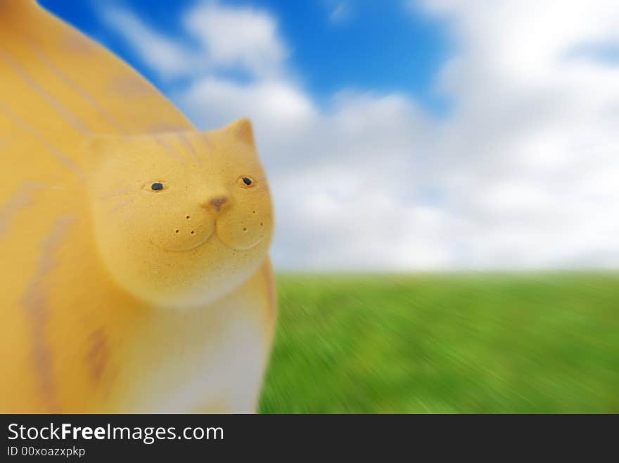 Cat figure over abstract of cloudy sky and grass. Cat figure over abstract of cloudy sky and grass