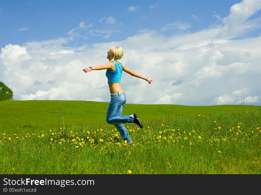 The girl jumping on a lawn