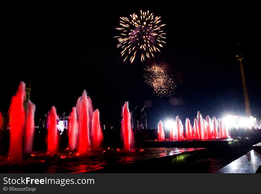 Beautiful fireworks over colored fountains. Beautiful fireworks over colored fountains