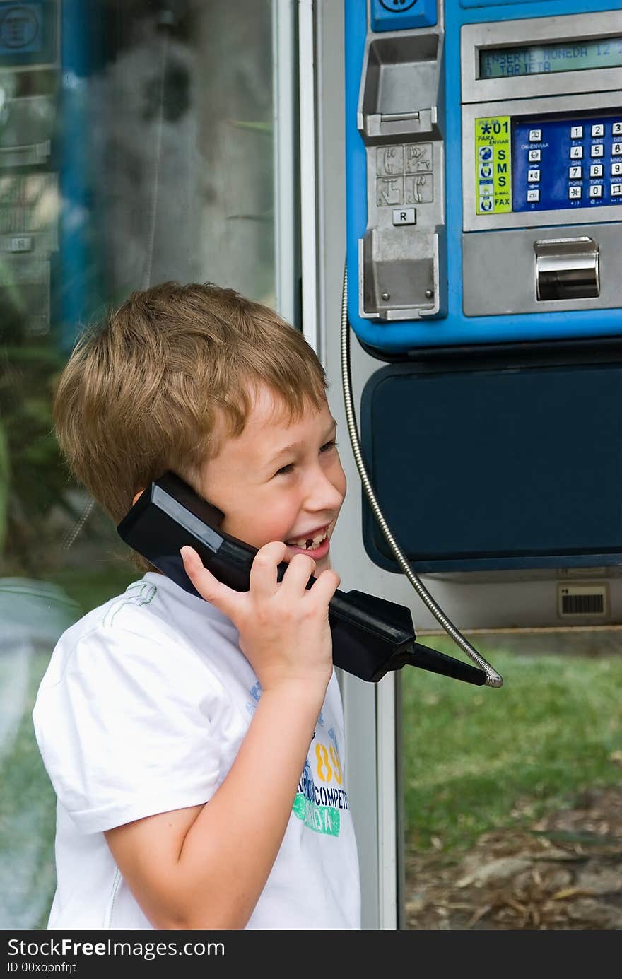 The cheerful boy is dared and speaks by phone