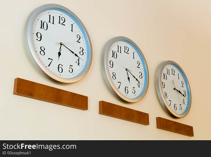 Row of clocks hanging on wall. Row of clocks hanging on wall