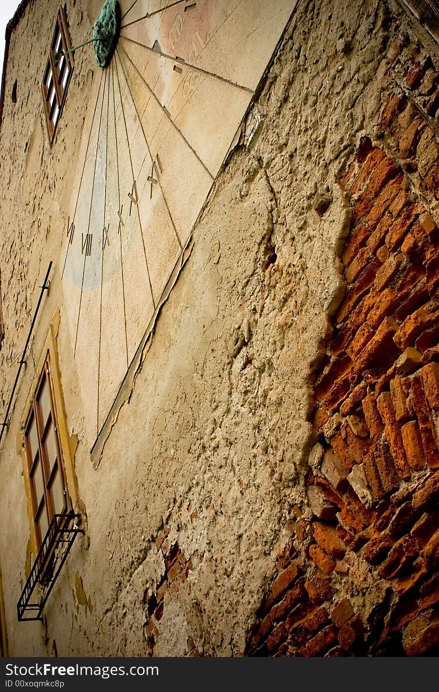 Ancient Sundial On The Yellow Stucco Wall