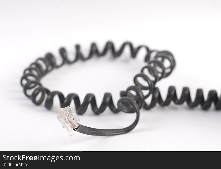 Black spiral phone cable at white background