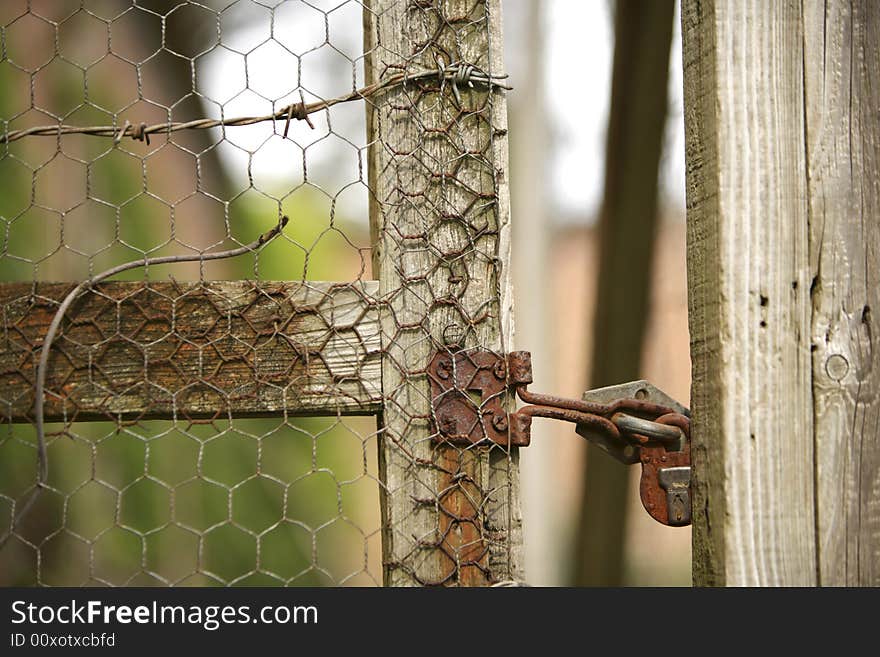 Old lock secures a garden fence