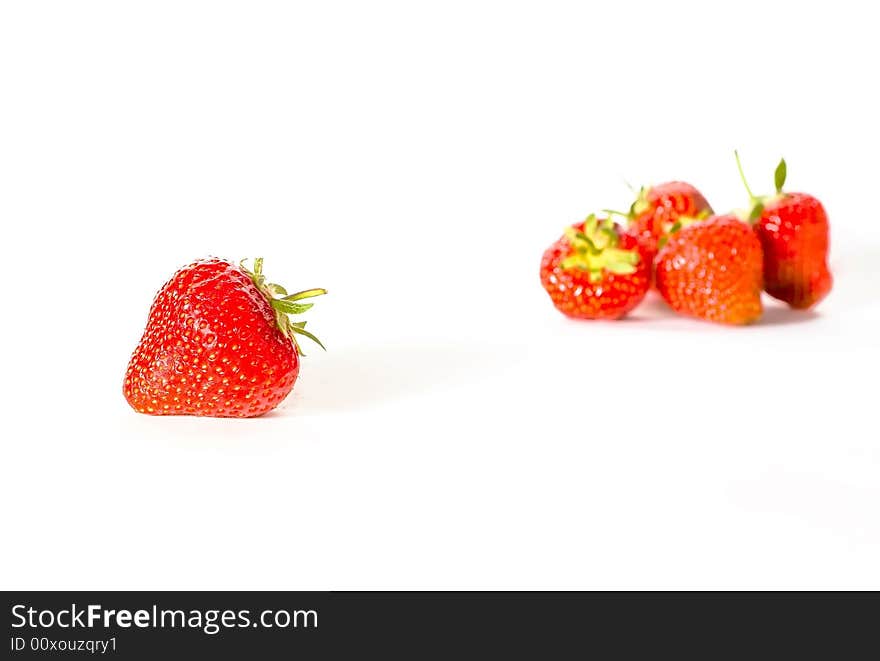 Five strawberries om the white background