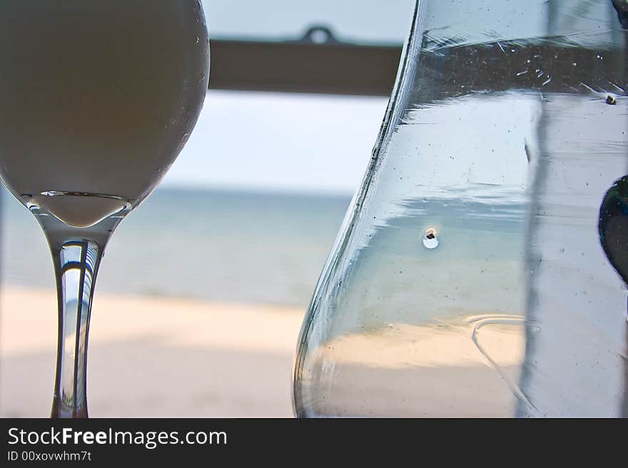 Frozen drink looking out a window at the sun waves and sand. Frozen drink looking out a window at the sun waves and sand