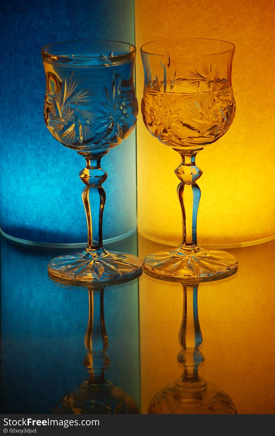 Two glasses on yellow-blue background