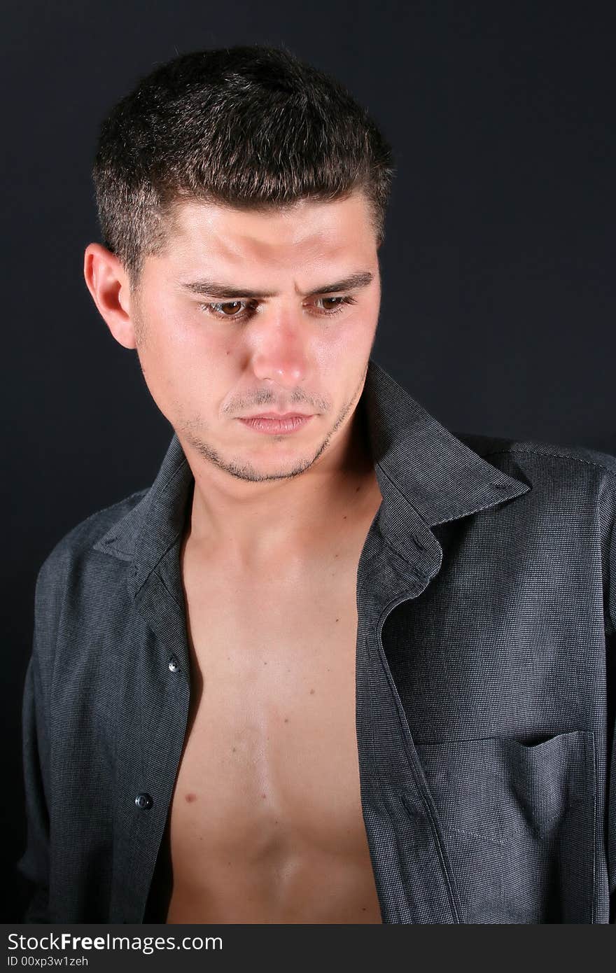 Male model in studio against black background