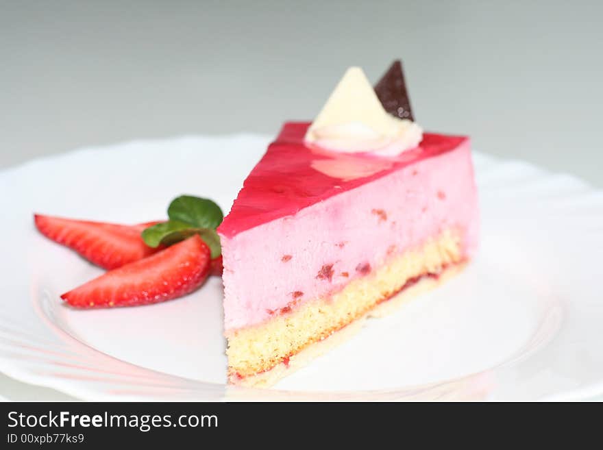 Slice of  cake with strawberry, selective focus, flash. Slice of  cake with strawberry, selective focus, flash