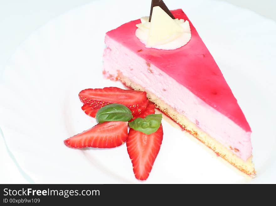 Slice of  cake with strawberry, selective focus, flash. Slice of  cake with strawberry, selective focus, flash