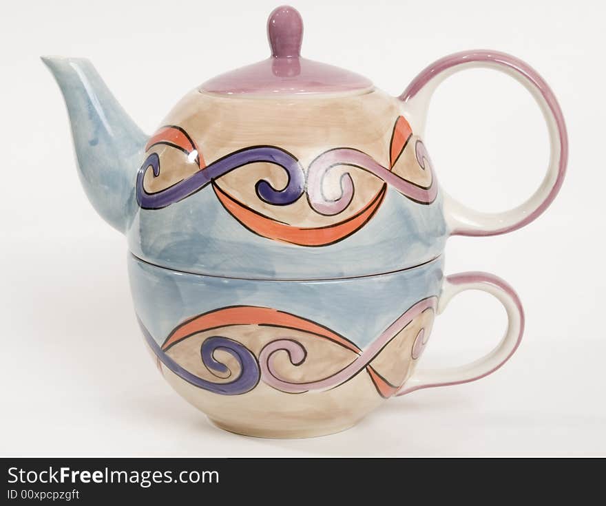 Tea pot and cup that stack together. Tea pot and cup that stack together