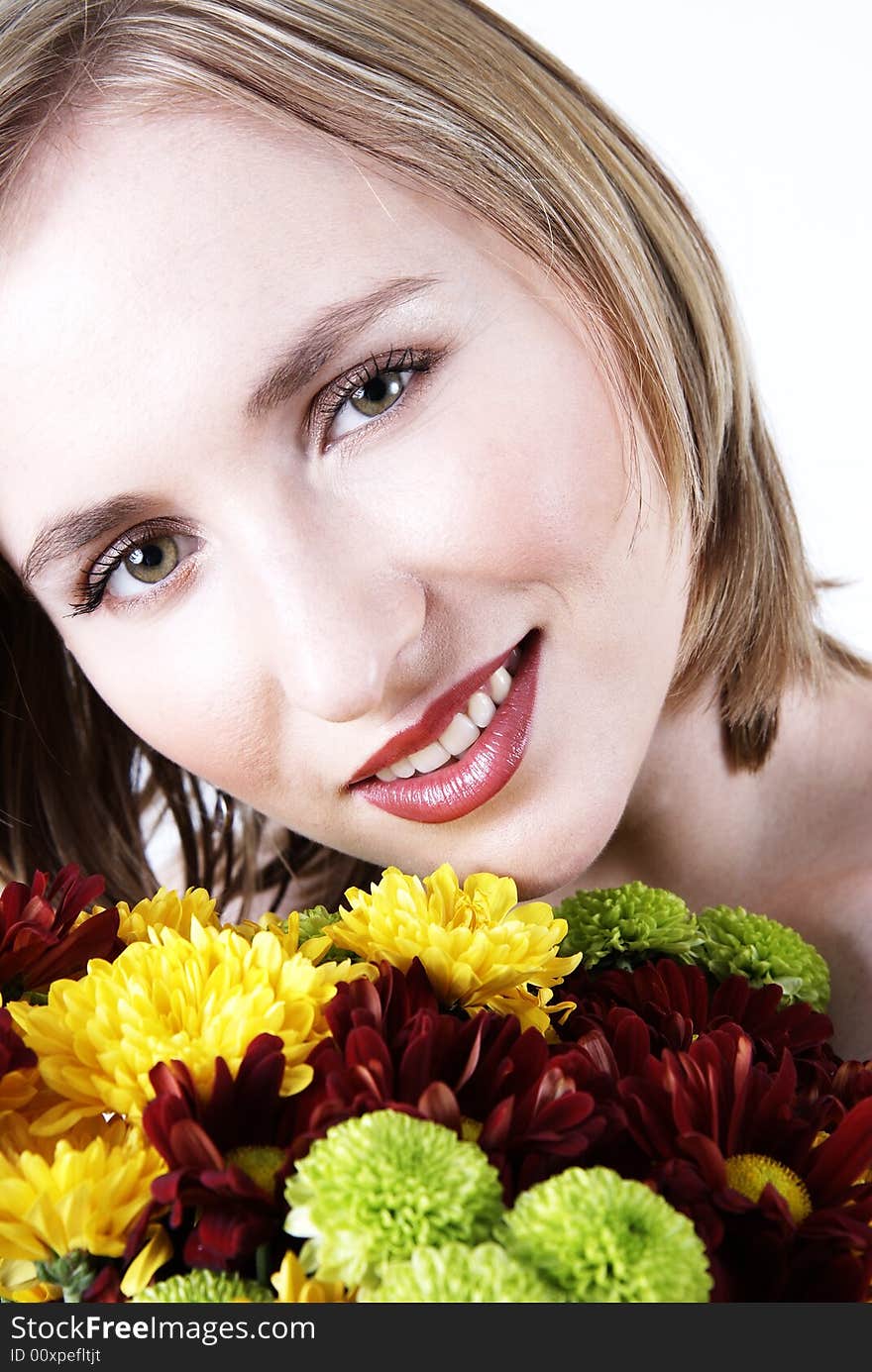 Beautiful blonde woman with bright makeup holding a bunch of flowers. Beautiful blonde woman with bright makeup holding a bunch of flowers