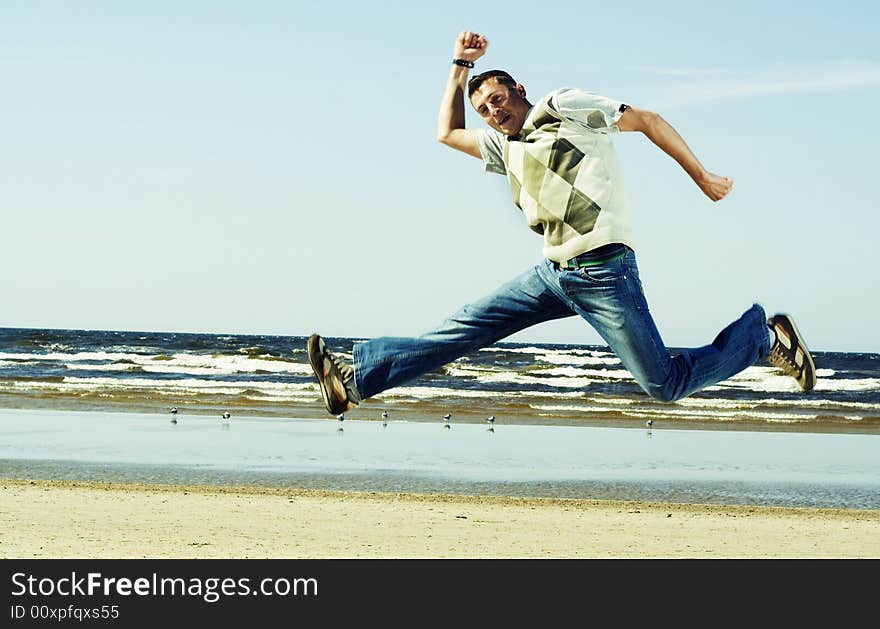 Young happy men jumping on the beach. Young happy men jumping on the beach.