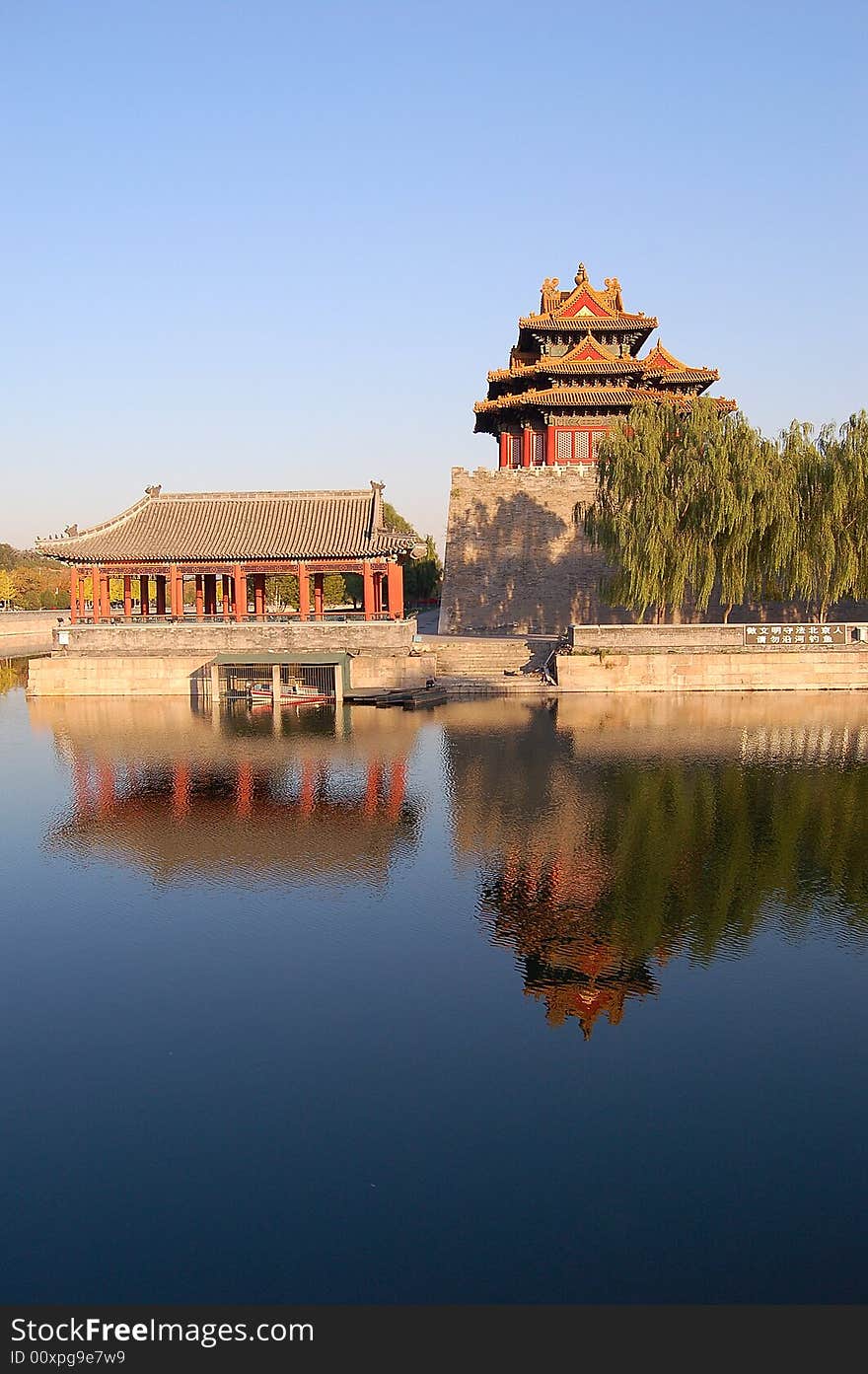 Turret, willows and their reflections on moat in the northwest corner of forbidden city, Beijing China. Turret, willows and their reflections on moat in the northwest corner of forbidden city, Beijing China.