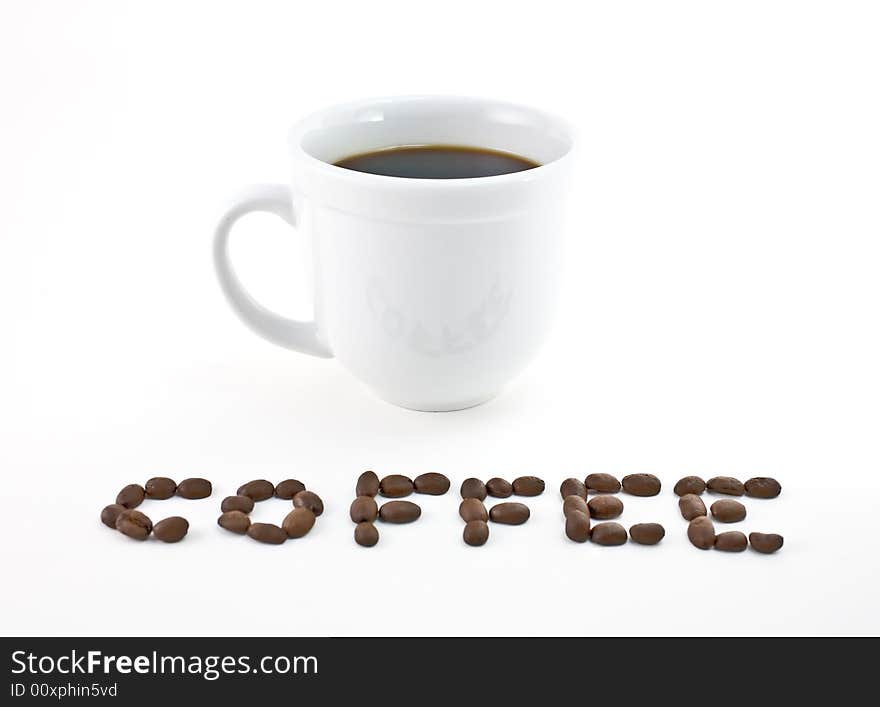 Coffee cup with the word coffee spelled out in beans.