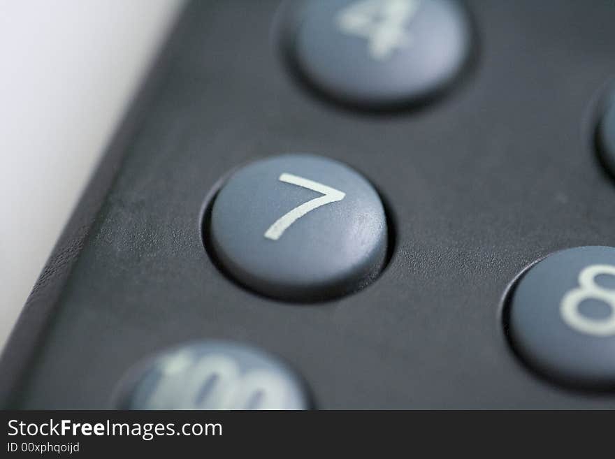 A close up of a number seven button on a remote control