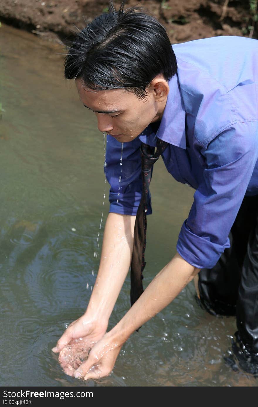 Man washing his face at river