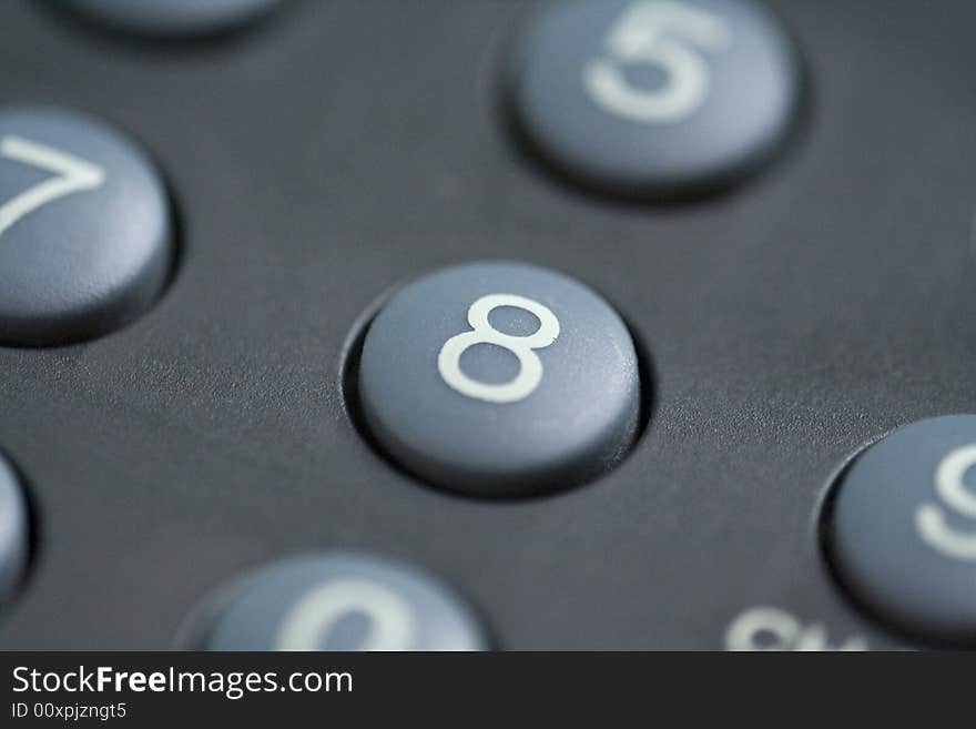 A close up of a number eight button on a remote control