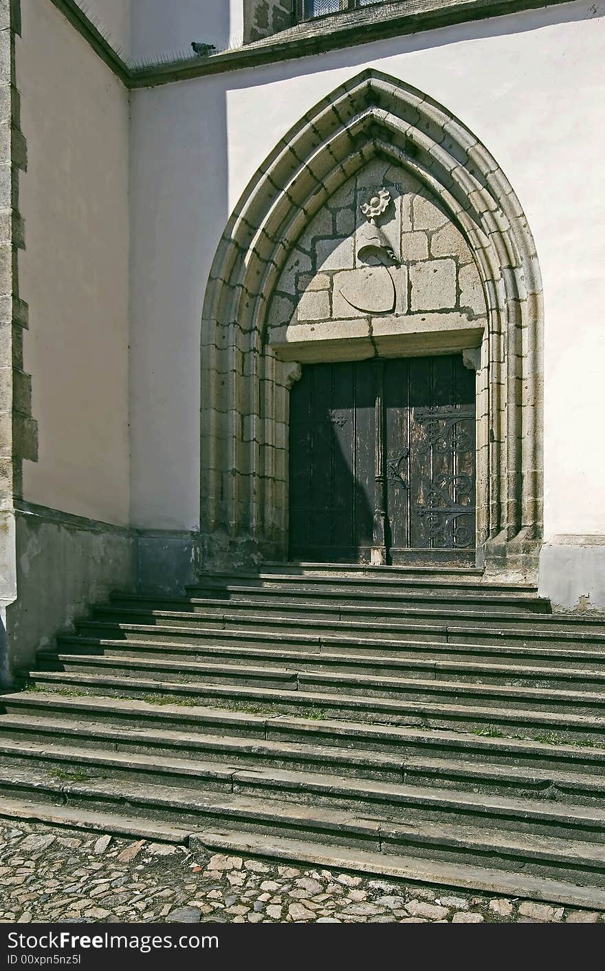 Old staircase and a gate to church