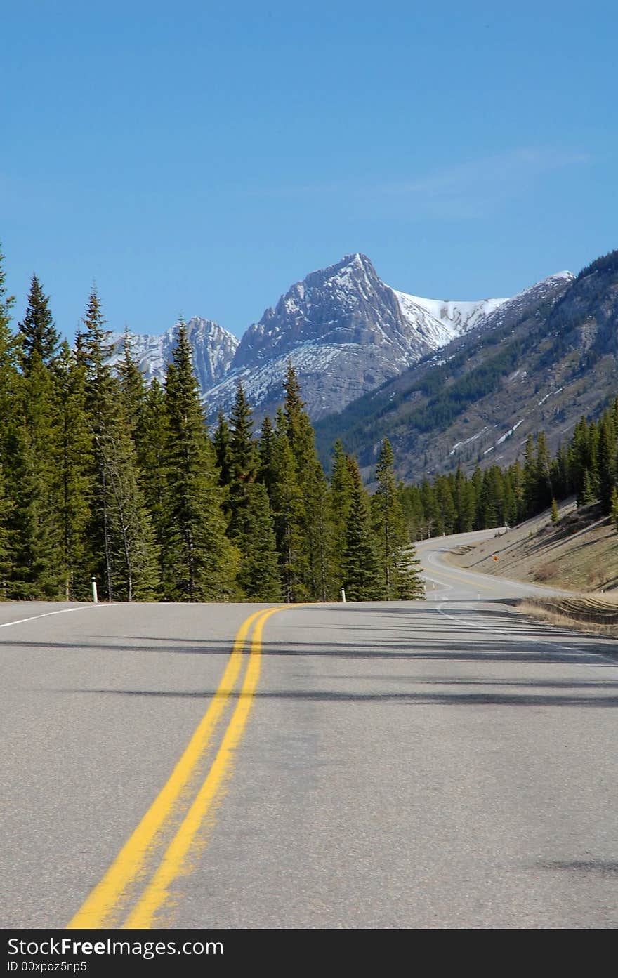 View of mountain peak and winding highway in kananaskis county, alberta, canada. View of mountain peak and winding highway in kananaskis county, alberta, canada