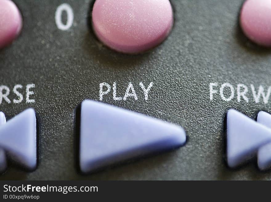 A close up of a play button on a remote control