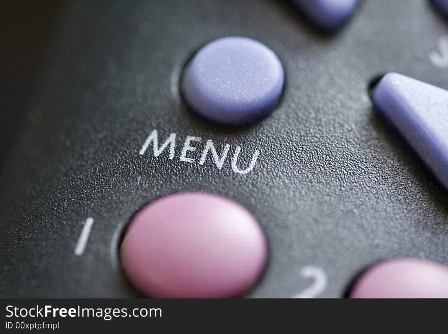 A close up of a menu button on a remote control