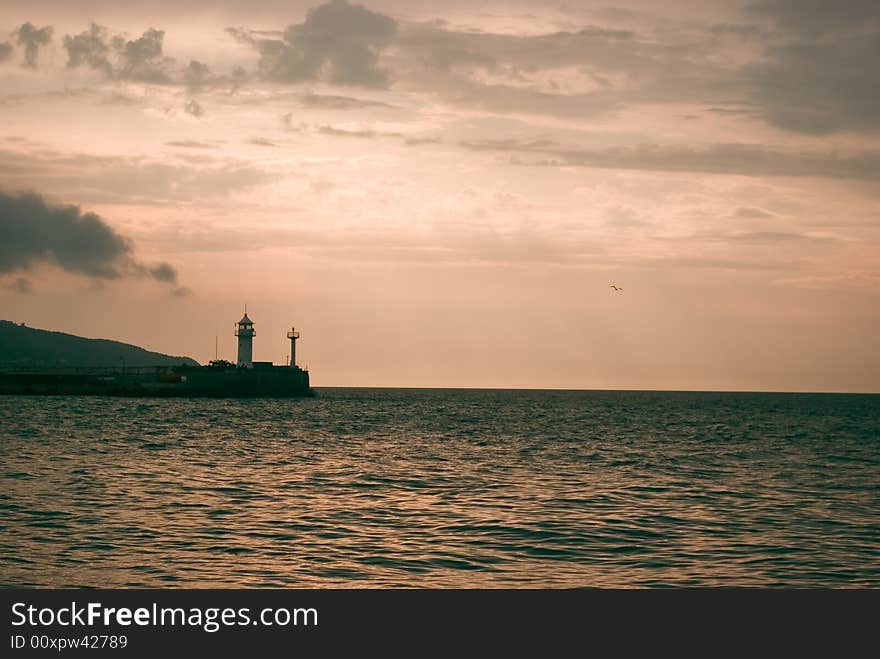 Cloudy sunrise above seamark