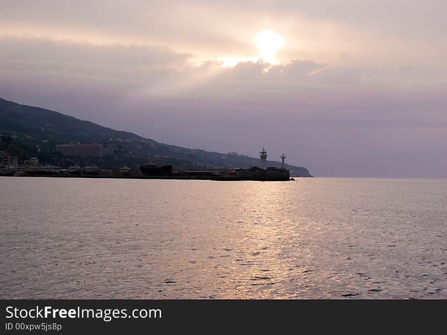 Cloudy sunrise above seamark, Yalta