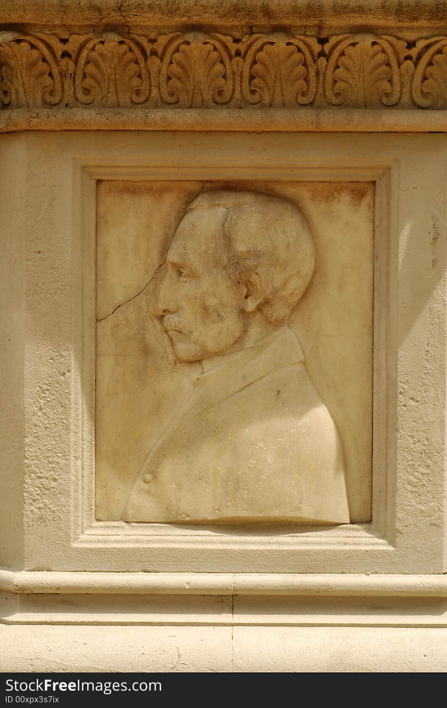 A heritage stone carving of a man face on wall element