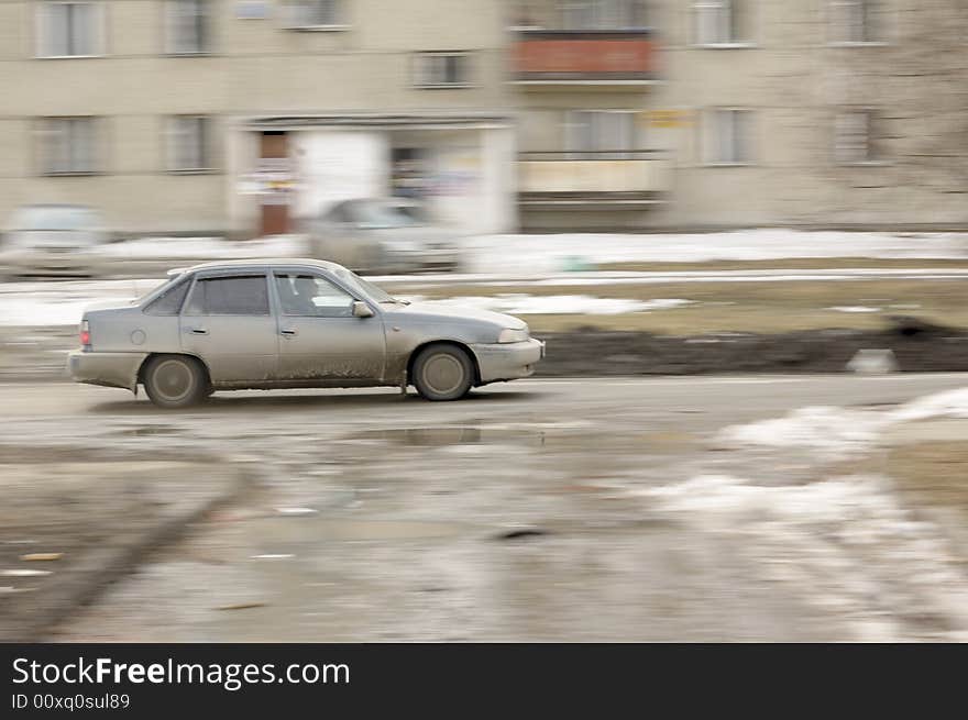 Photo of a car moving on a mud street. Photo of a car moving on a mud street